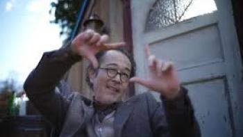 The Parades: An Asian man gestures outside
