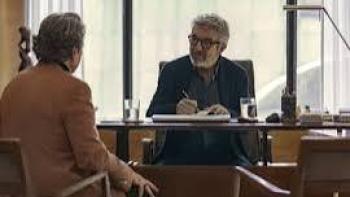 Therapy Done Right Movie: Two men talking across a desk in a well-lit office.