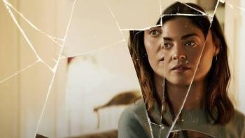 The Secret Woman: Woman's reflection in cracked mirror, thoughtful expression.