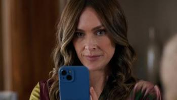 The Seemingly Perfect Family: Woman with long hair holding a blue smartphone, focused expression.