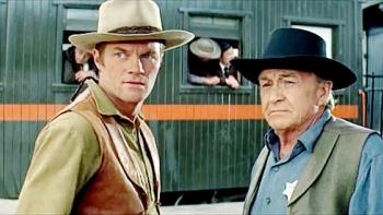 The Sons of Katie Elder: Two White men in cowboy hats, one older with a sheriff's badge.