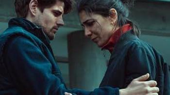 The Truthers Movie: A couple in a tender embrace, looking worried outdoors.