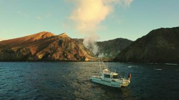 Whakatāne, New Zealand resident Mark Linman views Whakaari/White Island from a boat.