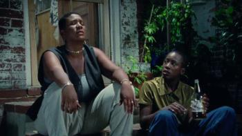 The Watermelon Woman: Two people sit on a step sharing a smoke and a bottle of beer. 