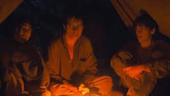 The Wilderness: Young men sit around fire