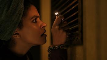 They Will Kill You Movie: Wearing a towel on her head, Asia Reaves (Zazie Beetz) holds a lighter up to an air vent
