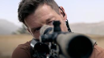 Sniper -- The Last Stand movie: Chad Michael Collins looking down a sniper's rifle