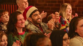 Tinsel Town: A smiling audience clap along to a Christmas pantomime, just out of shot