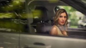 To Catch a Cheater: Woman with long hair sitting in a car, looking out the window.