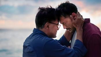 Today We'll Talk About That Day movie: Indonesian man in blue shirt center puts forehead to forehead of Indonesian man in red shirt on right