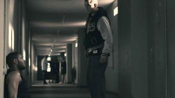 Tower Block: Kano and Nabil Elouahabi sit and stand in a hallway.