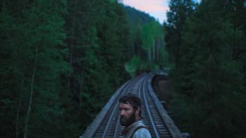Train Dreams: Joel Edgerton in front of a railway.