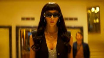 Transmitzvah: A woman with sunglasses on inside walks
