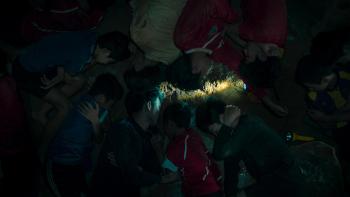 The Trapped 13 - How We Survived the Thai Cave: Top-down shot of Thai boys asleep in a cave.