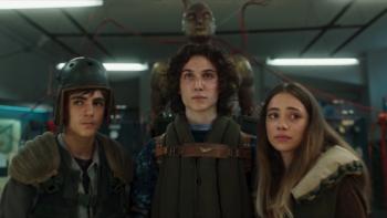The Voyagers: Two teenage boys and one teen girl stand in front of metal figures and wires