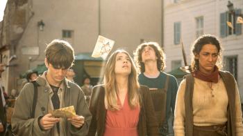 The Voyagers: A group of two teenage girls and two teenage boys in a sunlit street. One boy and girl are looking up to the sky