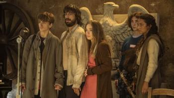 The Voyagers: A group of three males and two females stand in front of eagle statue