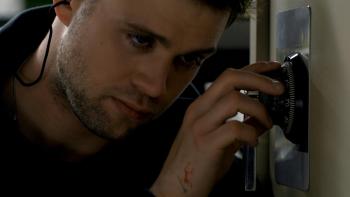 Tuner movie: Leo Woodall has his ear to a safe while he turns the dial