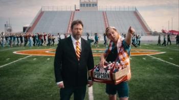 The Great Turkey Town Miracle Movie: Angus Benfield and another man stand on a football field facing the stands