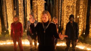 28 Years Later: The Bone Temple Movie: Jimmy (Jack O'Connell) gestures with his fingers, his followers behind him