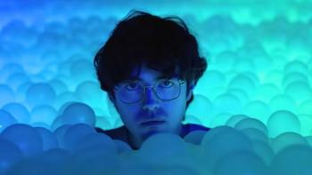 Twinless movie: James Sweeney looks sad and upset in a ball pit