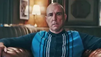 Untold UK -- Vinnie Jones: Vinnie Jones in striped sweater sits on a leather sofa in a cozy, dimly lit room