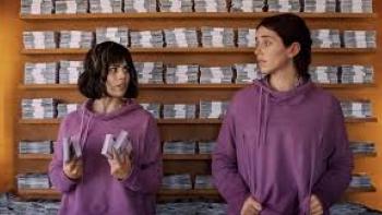 (Un)lucky Sisters: two women against a wall of money