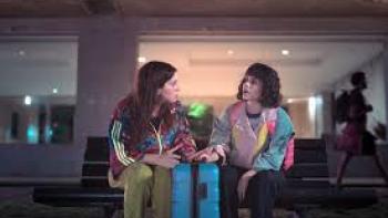 (Un)lucky Sisters:  Two women sit outside