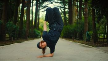 Untold Raygun: Breaking Badly movie: Raygun balances on one arm on a tree-lined path.