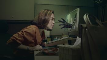 Untold Movie: Asian woman looks at computer as hand reaches out through screen