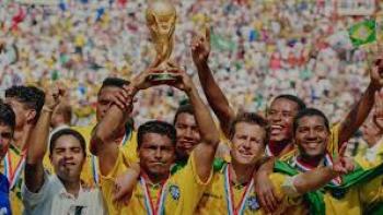 USA 94: Brazil's Return to Glory movie: Soccer team celebrating with World Cup trophy, wearing yellow jerseys and medals.