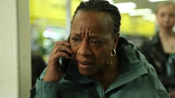 Hard Truths: A middle-aged Black woman on the phone looking concerned