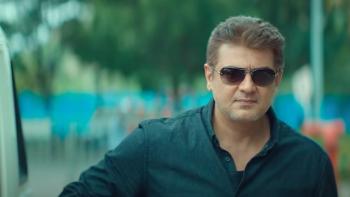 Valimai: Inspector Arjun Kumar in a blue shirt and sunglasses.