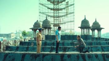 Valimai: Three men in conversation on the roof of a building.