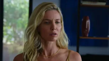 Vanished into the Night movie: White Italian woman with blond hair center looks serious in living room 