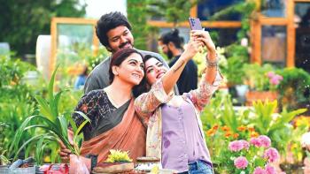 Varisu: An Indian man and two Indian women smile while taking a selfie