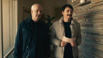 Villains Incorporated Movie: Colin Mochrie stands in a hallway with Jason Gray