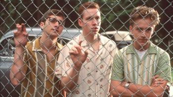 Liberty Heights: Three male students look through a fence