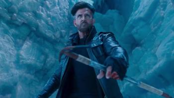 War 2: Indian man in black leather jacket holding a sword in an ice cave