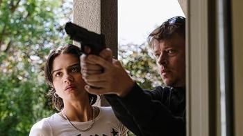 Wardriver movie: Dane DeHaan aims a gun at someone while Sashe Calle stands next to him