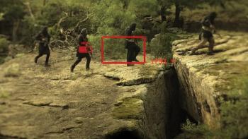 Warhorse One: Taliban insurgents cross gap holding rifles viewed through binoculars.