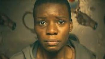 Weathering: closeup of Black woman's face looking worried or in pain