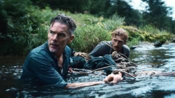 The Weight Movie: Murphy and Rankin maneuver a makeshift raft as they cross a river, in the water up to their chests