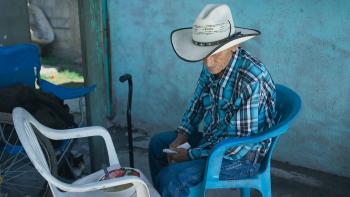 Julían Moreno eats a meal outside of his home.