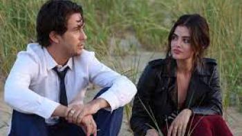 Which Brings Me to You Movie: Nat Wolff and Lucy Hale sit next to each other on the sand