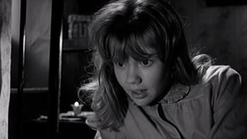 Whistle Down the Wind: A young blond girl, sitting on a bed in night dress, leans forward