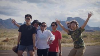 Still from Who We Become: Filipino social activist Monica Silverio (far right) and four members of her family on a road trip in Big Bend, Texas, wearing casual attire that includes shorts, T-shirts, and sunglasses