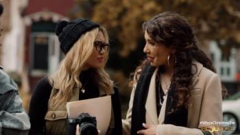 Two women in earnest conversation walking outdoors.