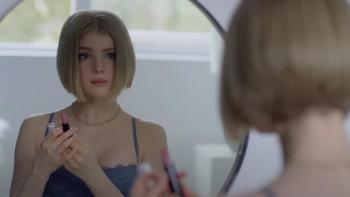 Wifelike: Elena Kampouris looks into a mirror, just her head and shoulders visible.