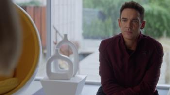 Wifelike: Jonathan Rhys Meyers sits wearing dark clothing, looking at someone out of shot.